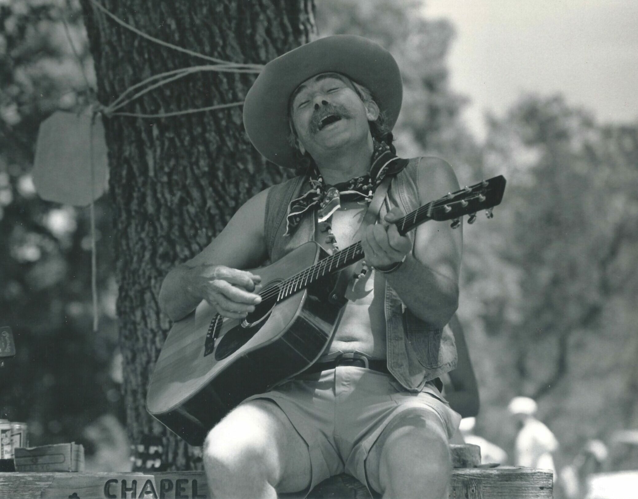 Frank singing and playing, eyes closed